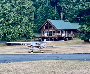 The Breidenthal Cessna in front of their cabin on the Blakely runway